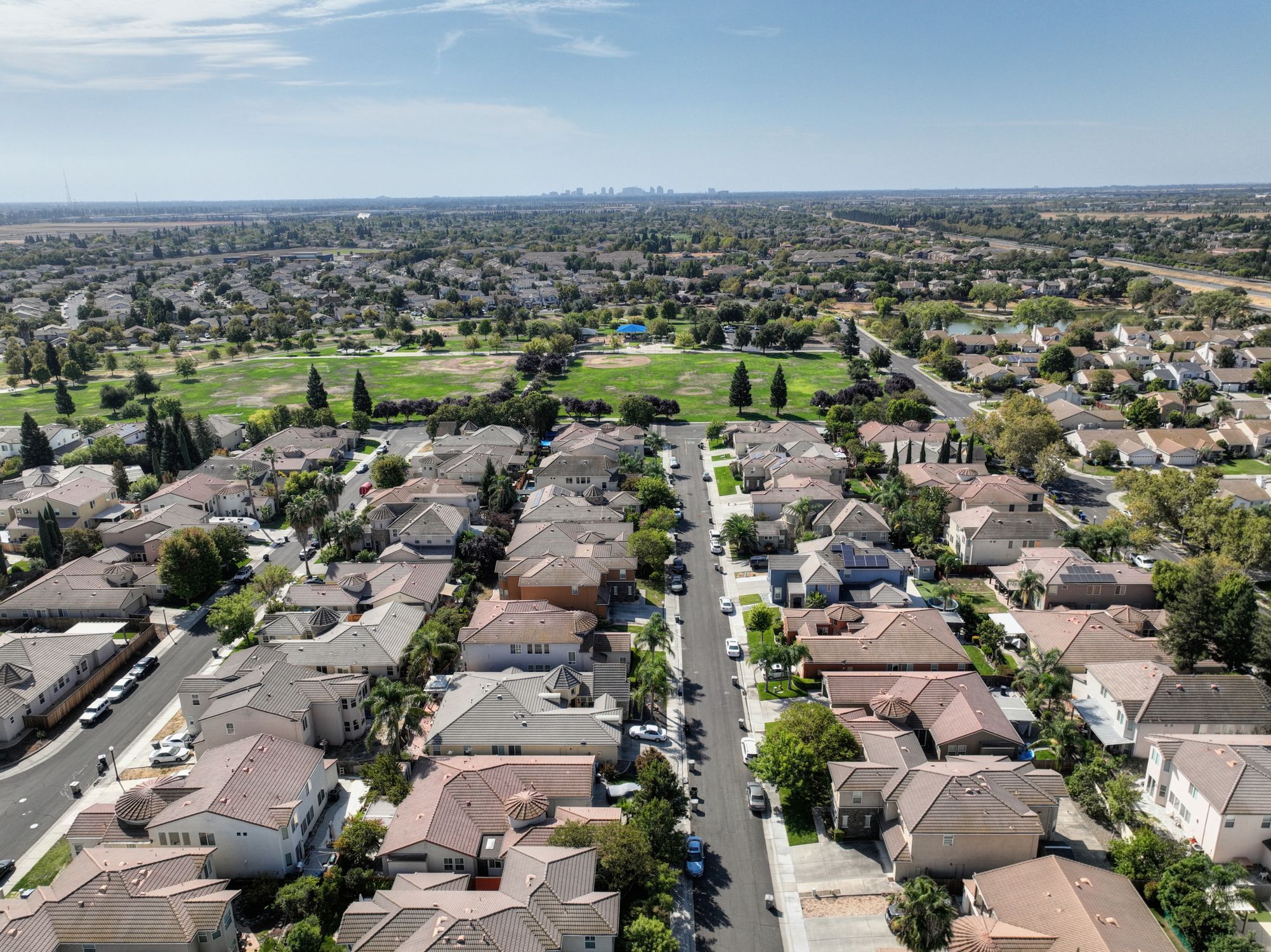 Aerial view of a tree-lined suburban neighborhood similar to Apex, NC's established communities